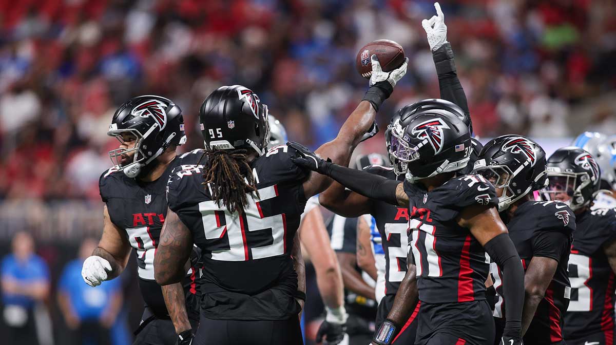 Atlanta Falcons defensive tackle Ta'Quon Graham (95) celebrates with teammates after recovering a fumble against the Detroit Lions in the second quarter at Mercedes-Benz Stadium. 