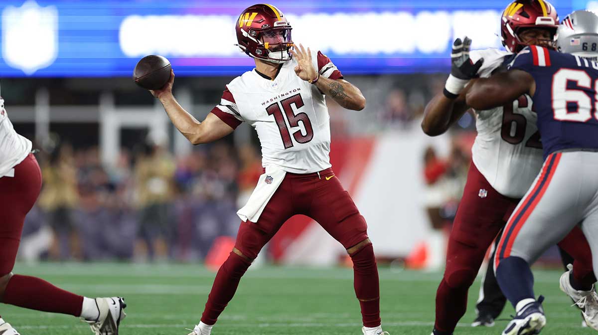 Washington Commanders quarterback Sam Hartman (15) passes the ball during the first half against the New England Patriots at Gillette Stadium.