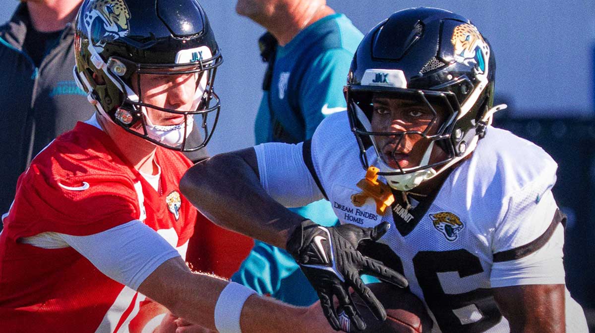 Jacksonville Jaguars quarterback John Wolford (18) hands off to Jacksonville Jaguars running back LeQuint Allen Jr. (36) during the Jacksonville Jaguars’ 18th and final training camp practice at Miller Electric Center in Jacksonville, Fla. Wednesday August 20, 2025. 