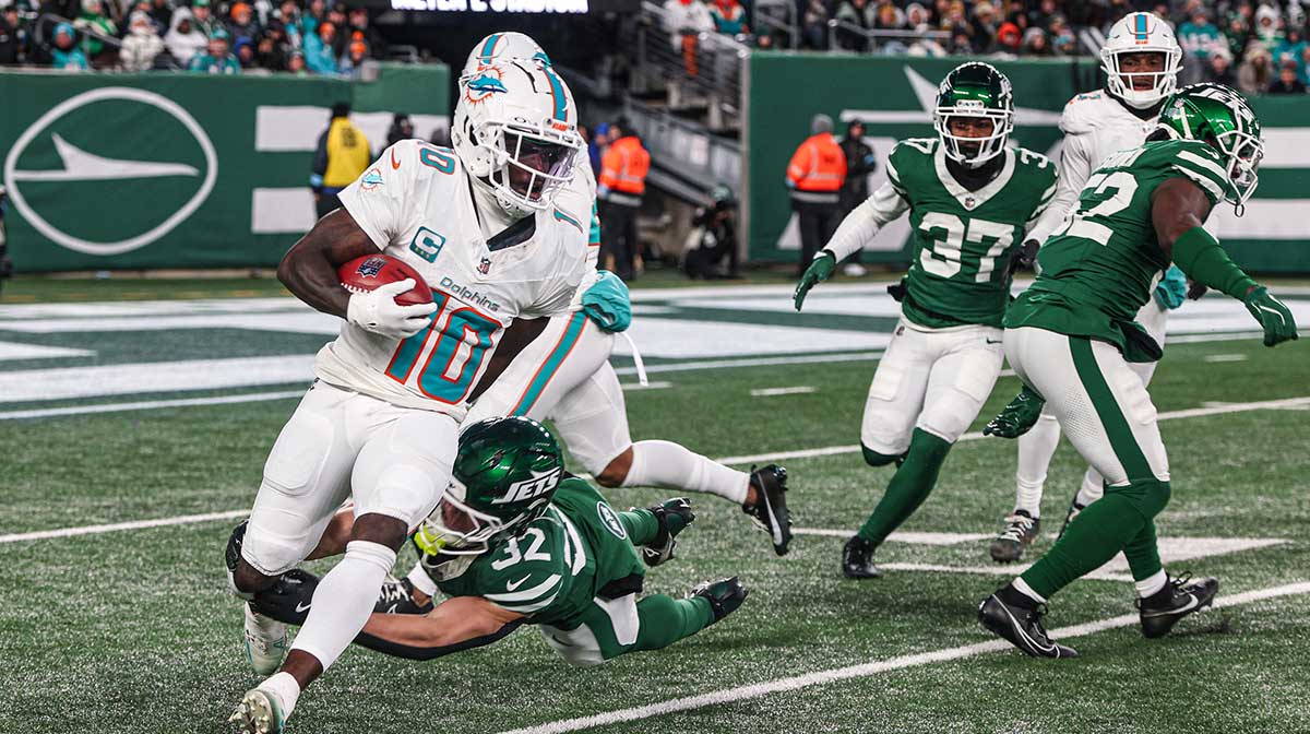 Miami Dolphins wide receiver Tyreek Hill (10) is tackled by New York Jets running back Isaiah Davis (32) during a punt return during the first half at MetLife Stadium.