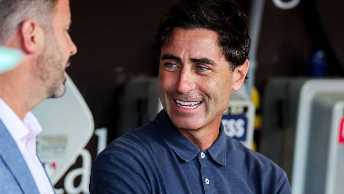 San Diego Padres general manager AJ Preller, right, talks with CEO Erik Greupner in the dugout before the game against the St. Louis Cardinals at Petco Park.