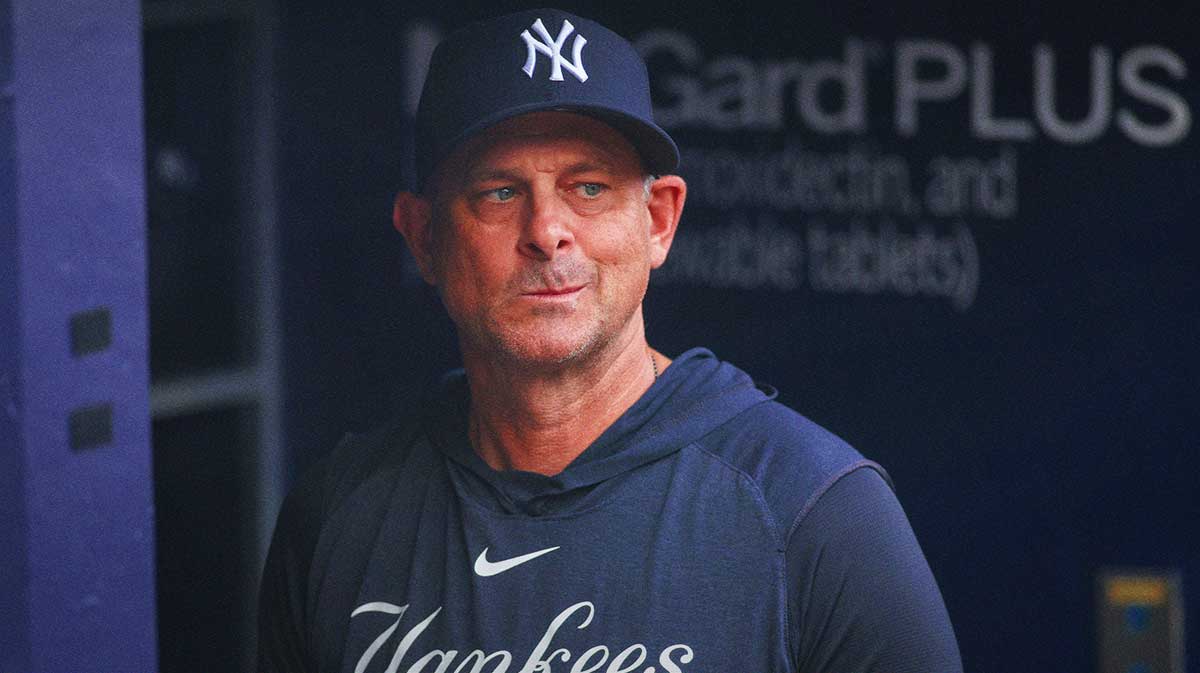 New York Yankees manager Aaron Boone (17) in the dugout before a game against the Atlanta Braves at Truist Park.