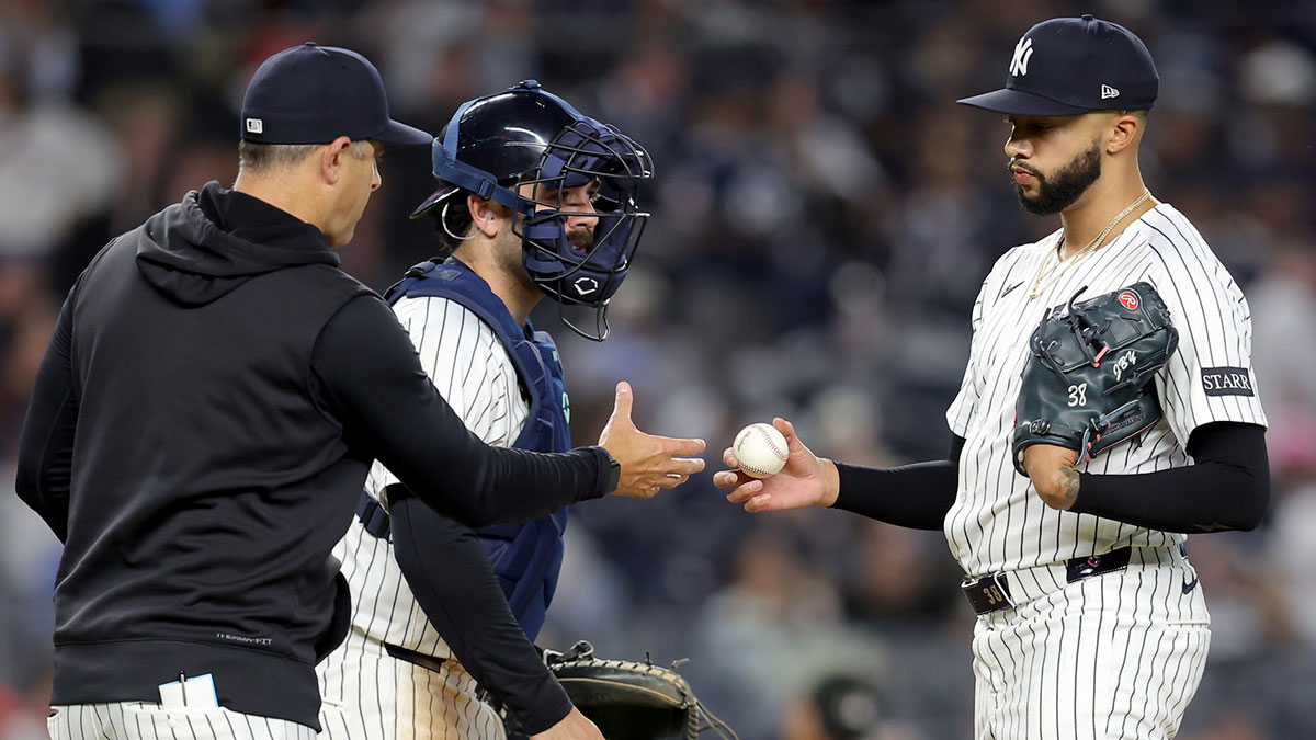 New York Yankees manager Aaron Boone (17) takes the ball from relief pitcher Devin Williams (38) during a pitching change during the ninth inning against the Toronto Blue Jays at Yankee Stadium.