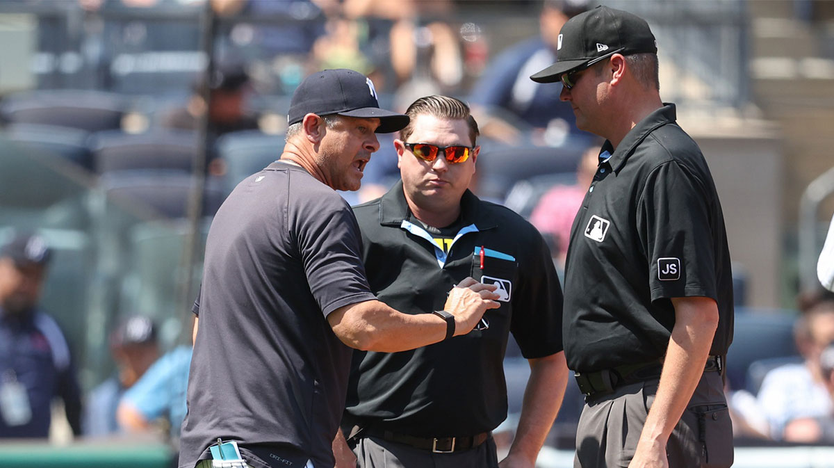 New York Yankees manager Aaron Boone (17) argues with umpires Derek Thomas (53) and Jordan Baker (71) in the third inning against the Houston Astros at Yankee Stadium.