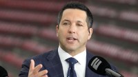 Adam Schefter talks on a set before the 2024 College Football Playoff national championship game between the Michigan Wolverines and the Washington Huskies at NRG Stadium.