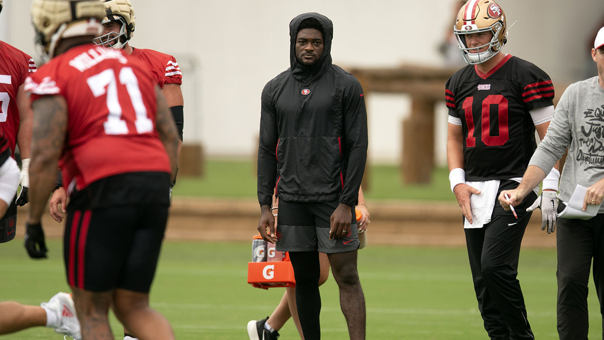 San Francisco 49ers wide receiver Brandon Aiyuk (in black hoodie) watches his teammates work out during the second day of training camp.