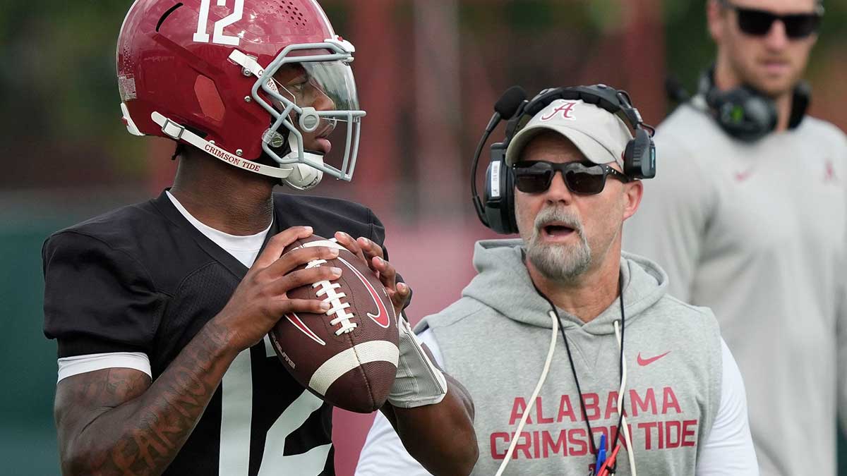 Quarterback Keelon Russell drops back under the watch of offensive coordinator Ryan Grubb during the first practice session of the preseason for the Alabama Crimson Tide.