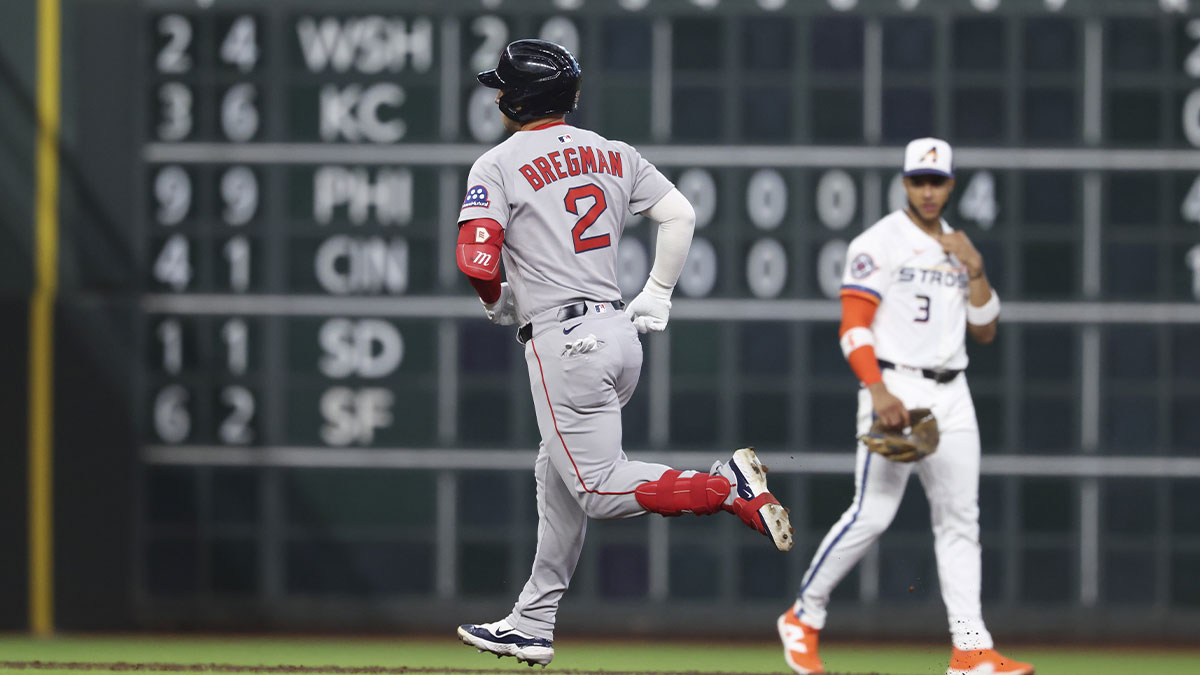 Houston Astros shortstop Jeremy Pena (3) looks on and Boston Red Sox third baseman Alex Bregman (2) rounds the bases after hitting a home run during the first inning at Daikin Park.