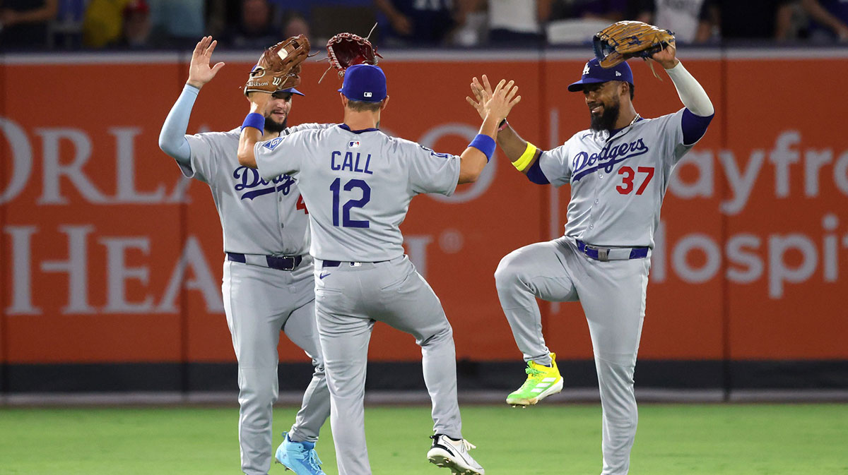 Los Angeles Dodgers outfielder Teoscar Hernandez (37), outfielder Andy Pages (44) and outfielder Alex Call (12) celebrate after they beat the Tampa Bay Rays at George M. Steinbrenner Field.