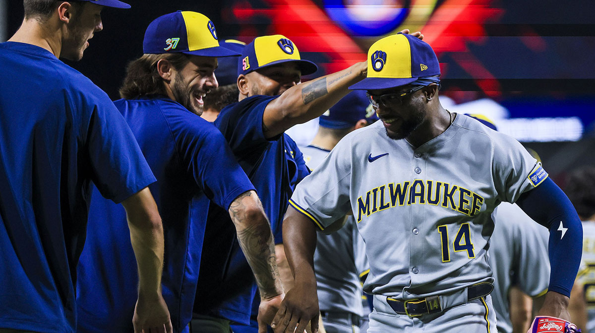 Aug 16, 2025; Cincinnati, Ohio, USA; Milwaukee Brewers outfielder Andruw Monasterio (14) high fives teammates after the victory over the Cincinnati Reds at Great American Ball Park. 