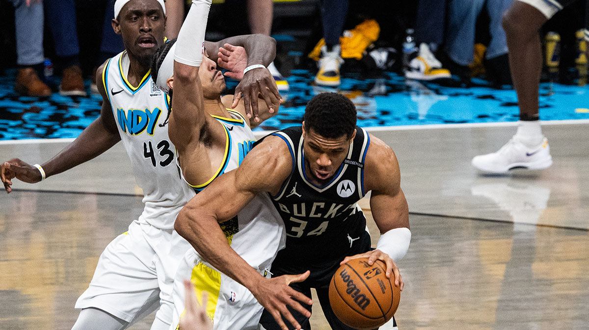 Milwaukee Bucks forward Giannis Antetokounmpo (34) dribbles the ball while Indiana Pacers guard Andrew Nembhard (2) defends during game five of the first round for the 2024 NBA Playoffs at Gainbridge Fieldhouse.