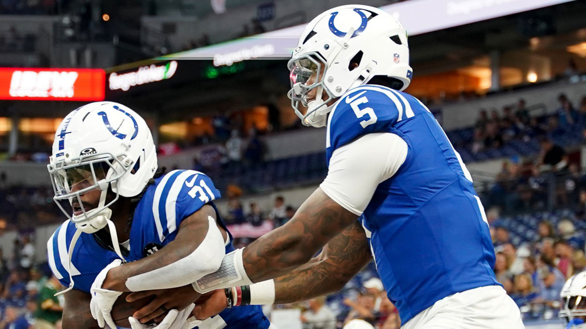 Indianapolis Colts running back Tyler Goodson (31) receives a handoff from Indianapolis Colts quarterback Anthony Richardson Sr. (5) during warmups prior to the game against the Green Bay Packers at Lucas Oil Stadium.