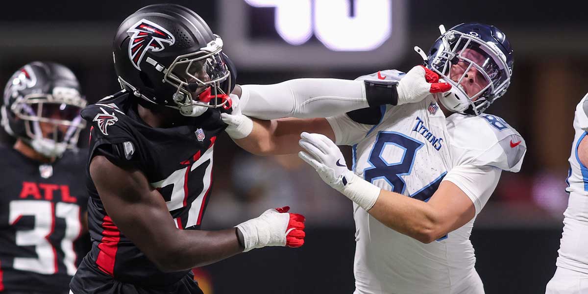 Atlanta Falcons linebacker James Pearce Jr. (27) is blocked by Tennessee Titans tight end Gunnar Helm (84) in the second quarter at Mercedes-Benz Stadium.