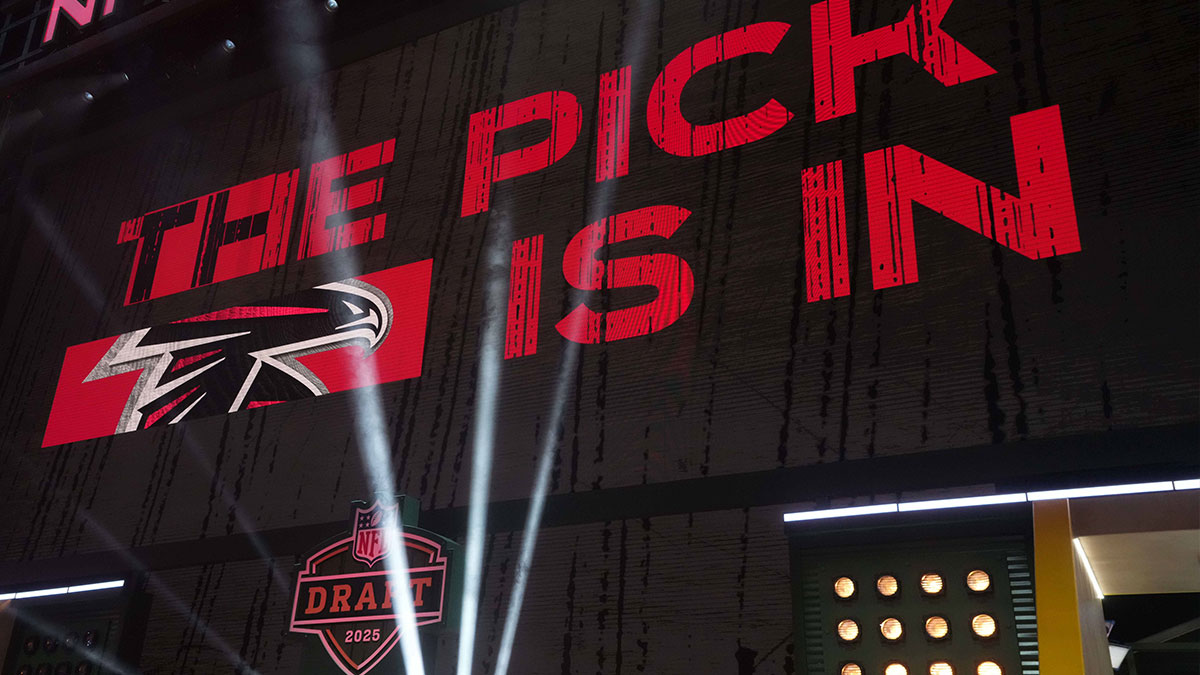 The Atlanta Falcons logo is projected on the video board during the NFL Draft at Lambeau Field.