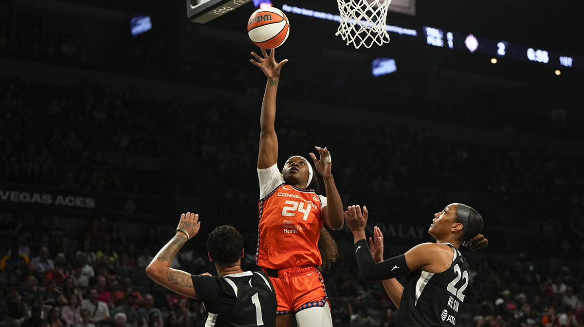 Connecticut Sun forward Aneesah Morrow (24) shoots the ball against Las Vegas Aces center A'ja Wilson (22) and forward Kierstan Bell (1) during the first half of a WNBA basketball game at Michelob Ultra Arena.