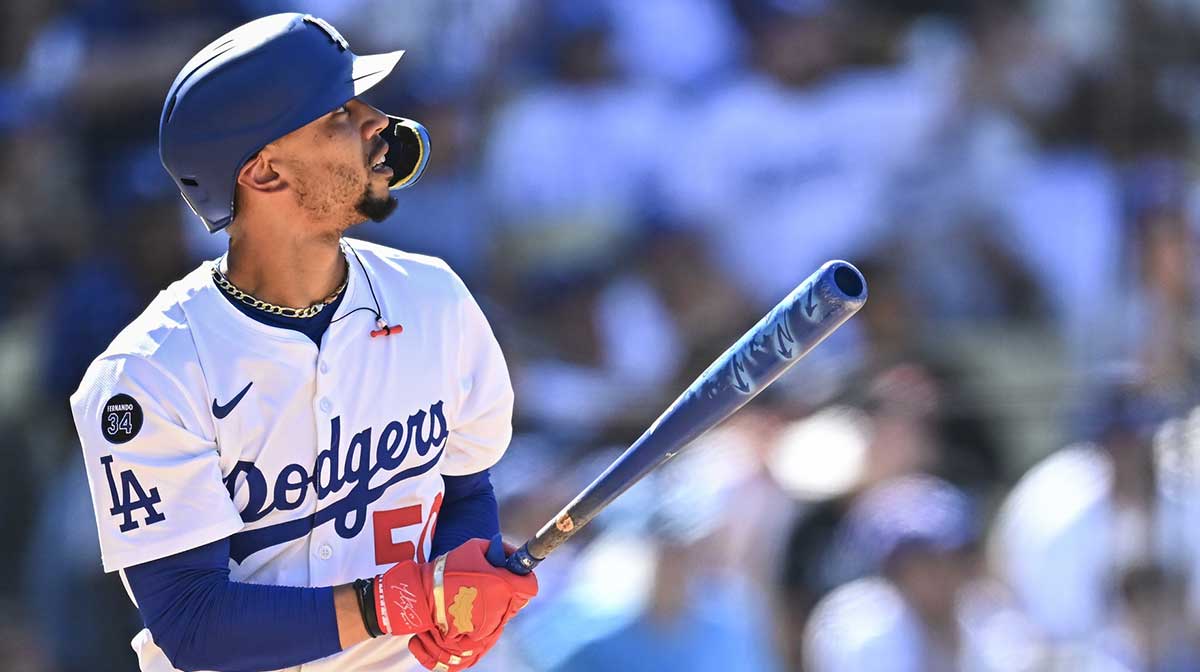 Los Angeles Dodgers shortstop Mookie Betts (50) hits a solo home run against the San Diego Padres during the eighth inning at Dodger Stadium. Mandatory Credit: Jonathan Hui-Imagn Images