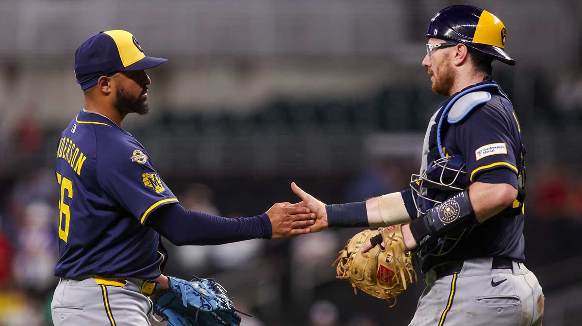 Aug 5, 2025; Atlanta, Georgia, USA; Milwaukee Brewers relief pitcher Grant Anderson (56) and catcher Danny Jansen (33) celebrate after a victory over the Atlanta Braves at Truist Park. Mandatory Credit: Brett Davis-Imagn Images