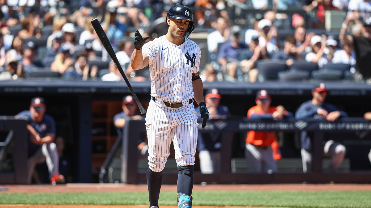 New York Yankees right fielder Giancarlo Stanton (27) flips his bat after walking with the bases loaded in the first inning against the Houston Astros at Yankee Stadium. Mandatory Credit: Wendell Cruz-Imagn Images
