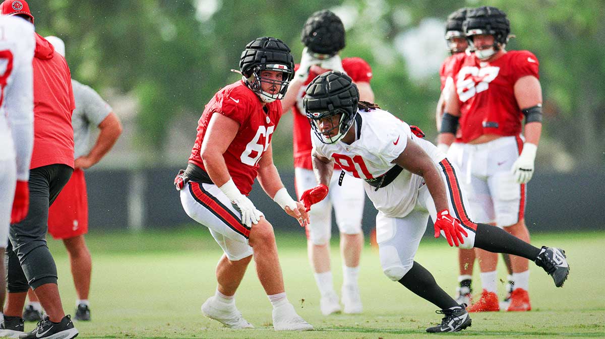 Tampa Bay Buccaneers center Jake Majors (65) and defensive end Mike Greene (91) participate in training camp at AdventHealth Training Center.