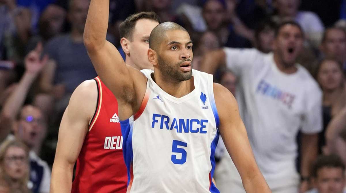 France small forward Nicolas Batum (5) reacts after scoring against Germany in the first half in a men’s group B basketball game during the Paris 2024 Olympic Summer Games at Stade Pierre-Mauroy.