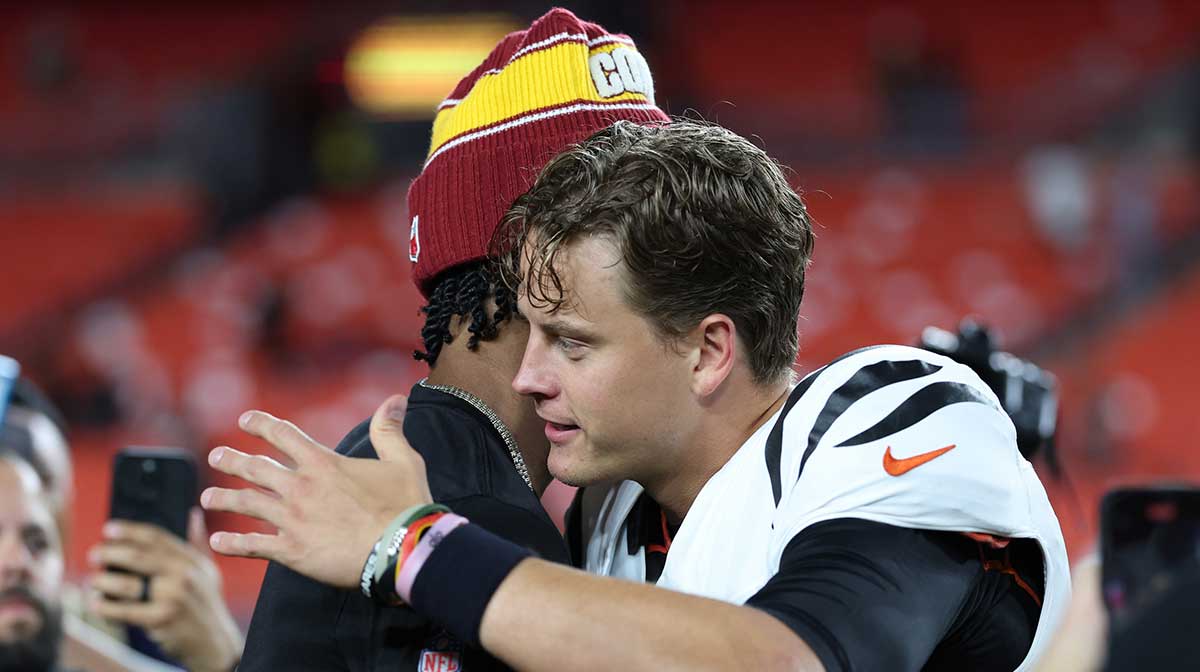 Bengals quarterback Joe Burrow (9) greets Washington Commanders quarterback Jayden Daniels (5) after their game at Northwest Stadium