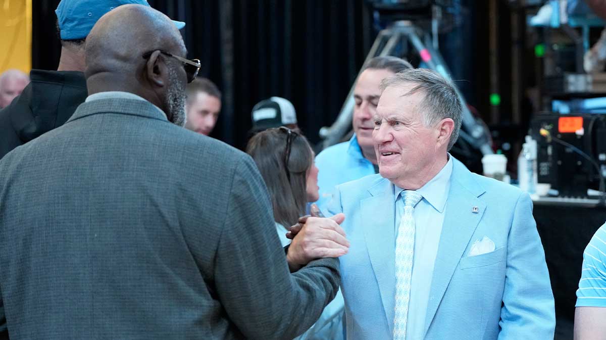 Former North Carolina Tar Heels great Lawrence Taylor with head football coach Bill Bellichick together during a time out in the first half at Dean E. Smith Center.
