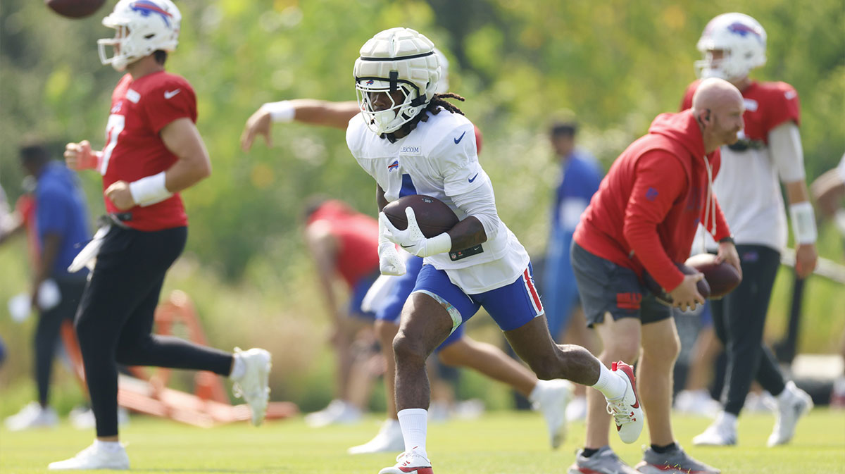 Buffalo Bills running back James Cook (4) runs on the field during joint training camp practice with the Chicago Bears ahead of Sunday's preseason game.