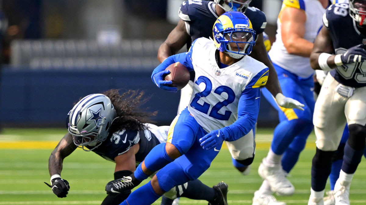 Los Angeles Rams running back Blake Corum (22) runs past Dallas Cowboys linebacker Marist Liufau (35) for a first down during the first half at SoFi Stadium.