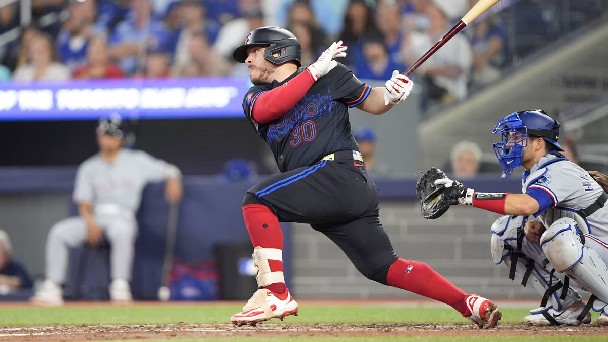 Toronto Blue Jays catcher Alejandro Kirk (30) hits a two run single against the Texas Rangers during the eighth inning at Rogers Centre. Blue Jays catcher Alejandro Kirk earns first career stolen base as manager John Schneider delivers hilarious reaction.