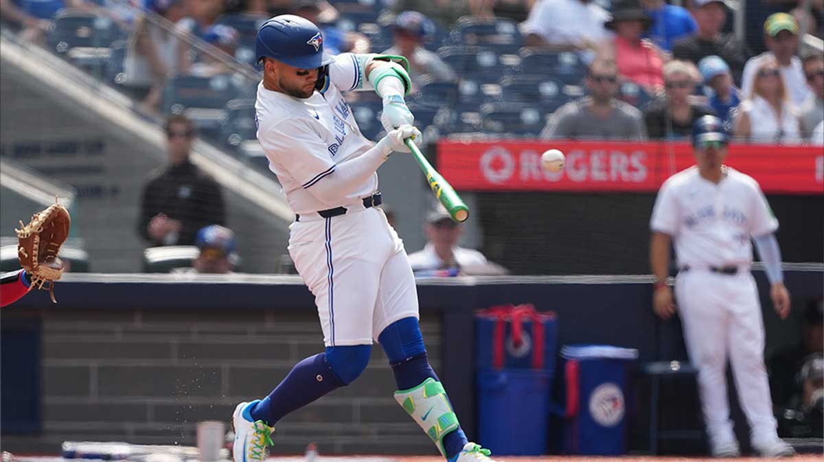 Toronto Blue Jays shortstop Bo Bichette (11) hits a single against the Texas Rangers during the the second inning at Rogers Centre.