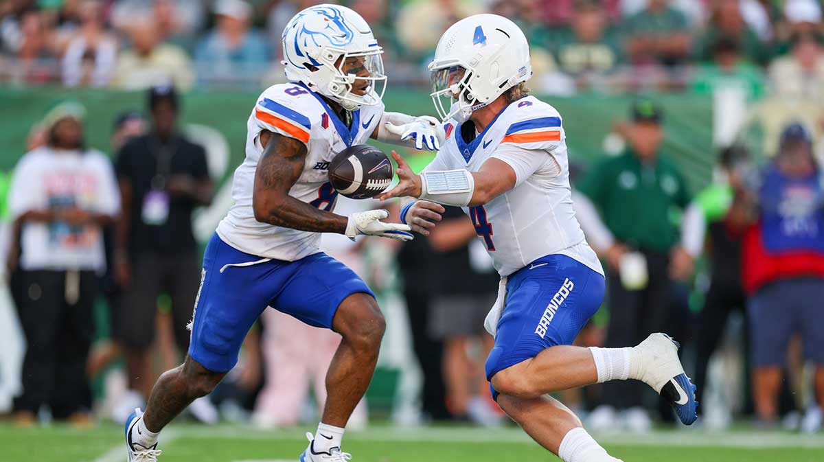 Boise State Broncos quarterback Maddux Madsen (4) hands off to Boise State Broncos running back Malik Sharrod (8) against the South Florida Bulls in the second quarter at Raymond James Stadium.