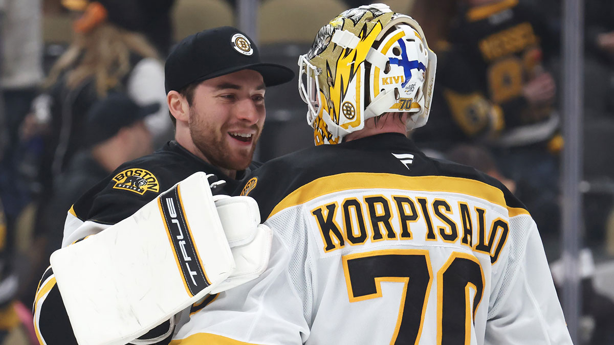 Boston Bruins goaltenders Jeremy Swayman (left) and Joonas Korpisalo (70) celebrate after defeating the Pittsburgh Penguins at PPG Paints Arena.