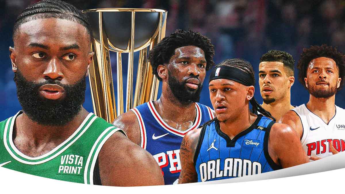 Celtics' Jaylen Brown next to the NBA Cup trophy with Joel Embiid, Paolo Banchero, Michael Porter Jr (Nets jersey), and Cade Cunningham on the other side of the trophy