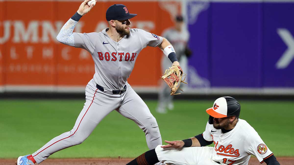 Boston Red Sox shortstop Trevor Story (10) throws to first as Baltimore Orioles is out at second for a double play during the sixth inning at Oriole Park at Camden Yards.