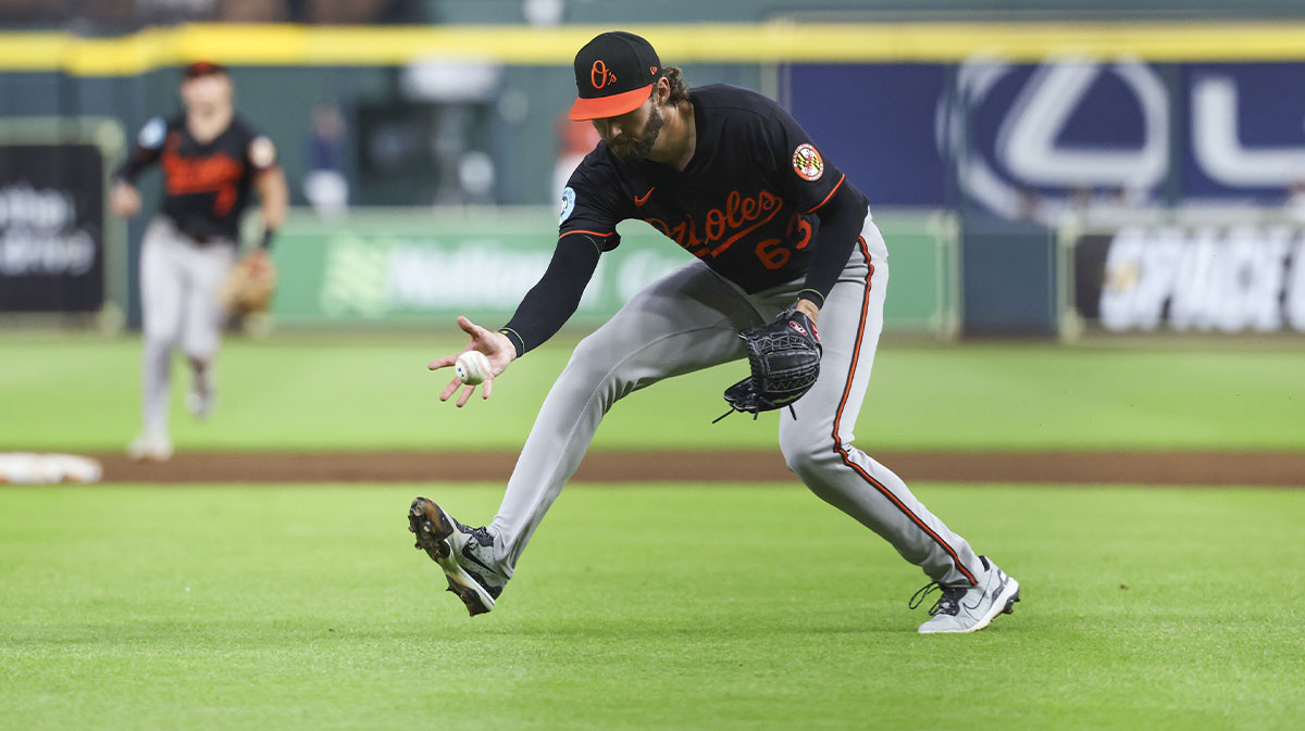 Baltimore Orioles starting pitcher Brandon Young (63) attempts to field a ground ball on a hit by Houston Astros second baseman Ramon Urias (not pictured) during the eighth inning at Daikin Park.