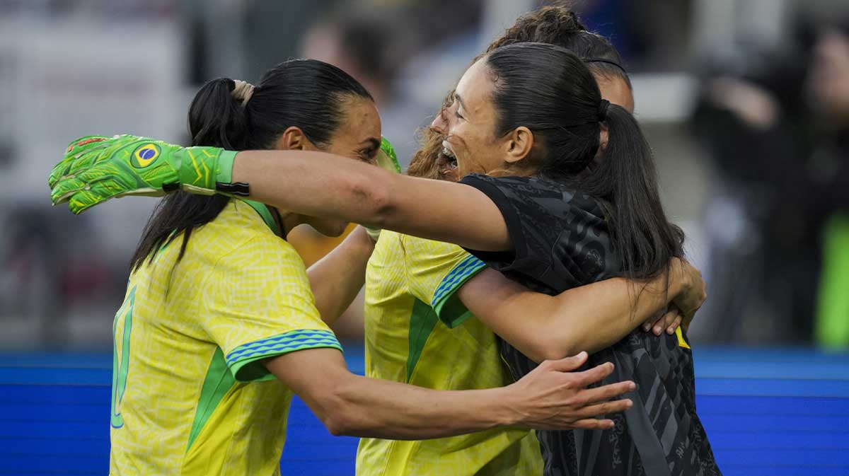 Brazil midfielder Angelina (8) celebrates with goalkeeper Lorena (1) and forward Marta (10) after defeating Japan in penalty kicks at Lower.com Field.