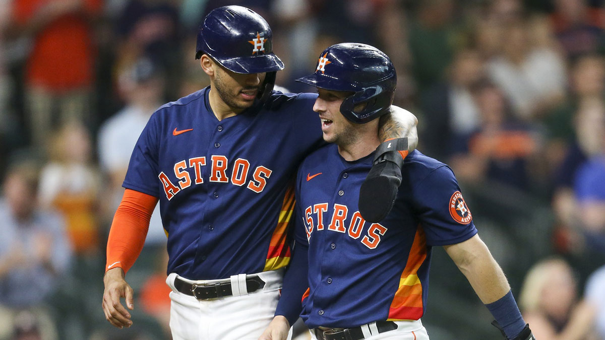 Houston Astros shortstop Carlos Correa (1) and third baseman Alex Bregman (2) celebrate scoring a two run RBI against the Texas Rangers in the eighth inning at Minute Maid Park.