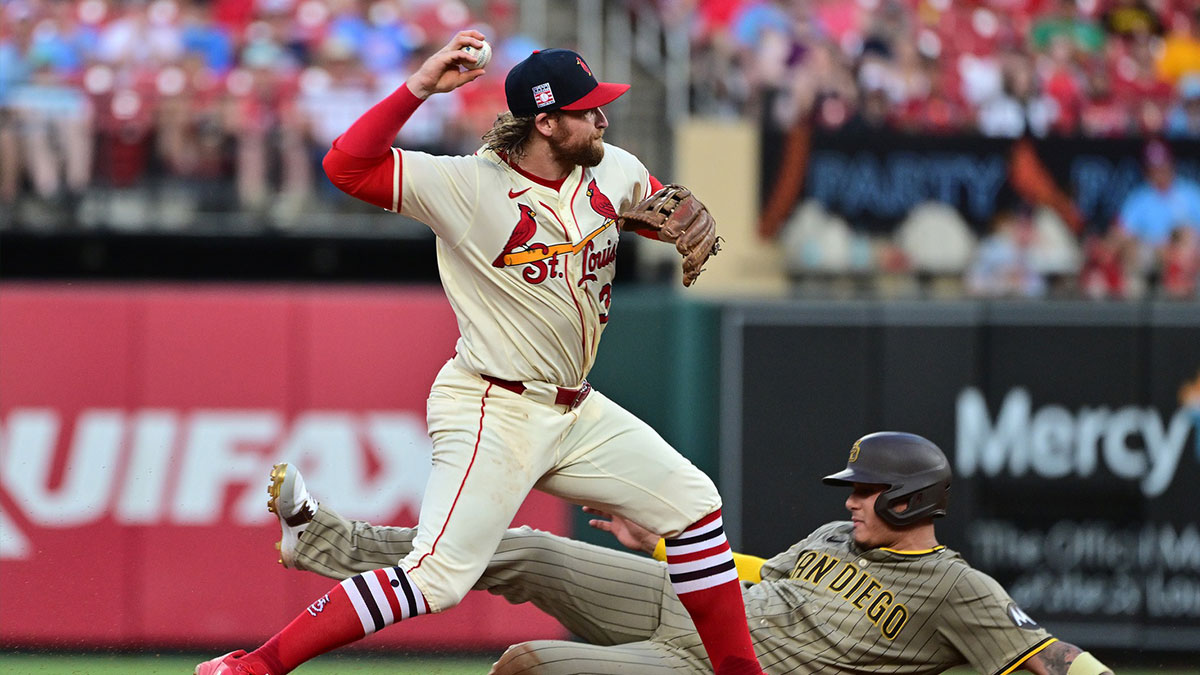 Jul 26, 2025; St. Louis, Missouri, USA; San Diego Padres third baseman Manny Machado (13) is out at second base as St. Louis Cardinals second baseman Brendan Donovan (33) tries in vain for a double play in the fifth inning at Busch Stadium. 