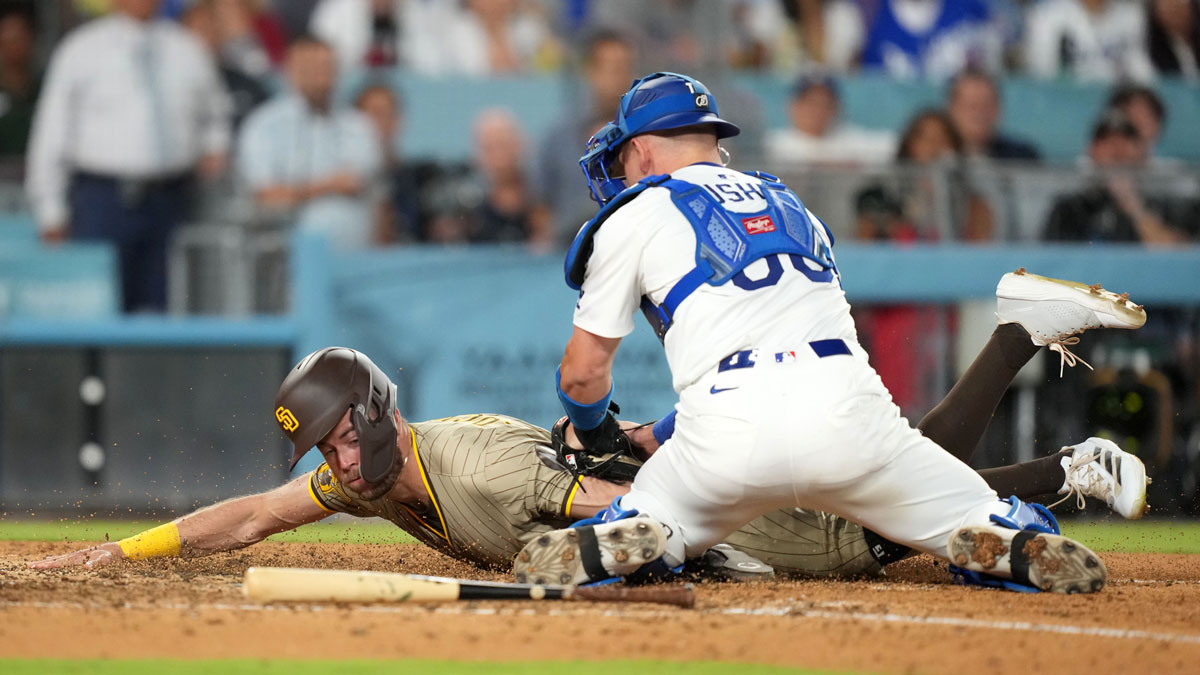 San Diego Padres pinch runner Brandon Lockridge (28) is tagged out at home plate by Los Angeles Dodgers catcher Dalton Rushing (68) in the ninth inning at Dodger Stadium. 