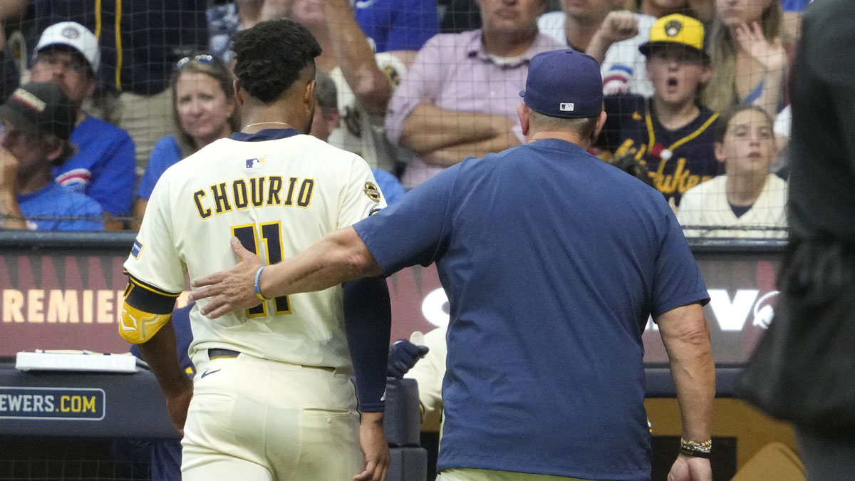 Milwaukee Brewers manager Pat Murphy (49) gives outfielder Jackson Chourio (11) a pat on the back after coming out of the game because of an injury against the Chicago Cubs in the fifth inning at American Family Field.