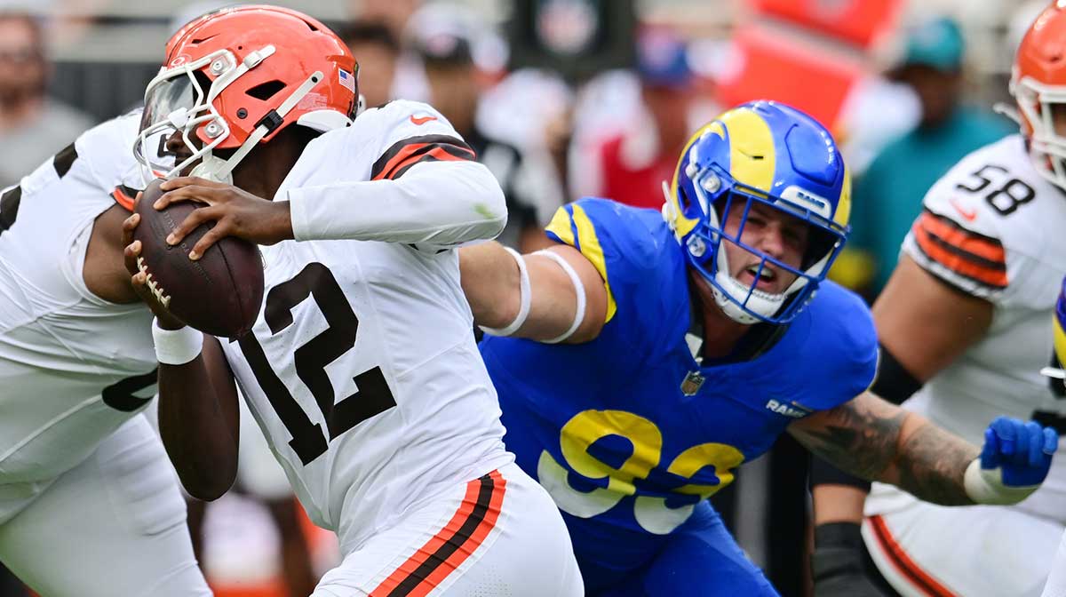 Los Angeles Rams defensive tackle Jack Heflin (93) grabs the jersey of Cleveland Browns quarterback Shedeur Sanders (12) during the second half at Huntington Bank Field.