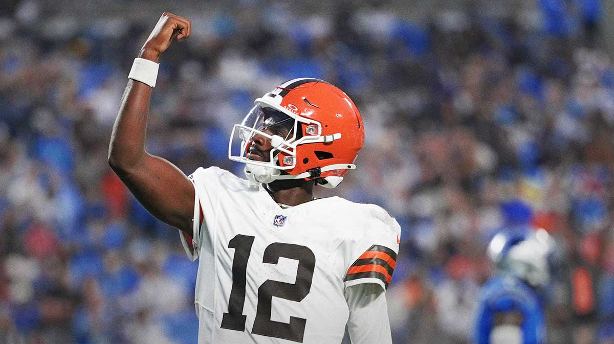 Browns quarterback Shedeur Sanders (12) celebrates his touchdown pass against the Carolina Panthers during the second quarter at Bank of America Stadium with Browns head coach Kevin Stefanski in the background