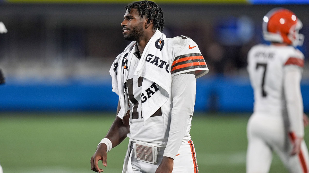 Browns quarterback Shedeur Sanders (12) greets teammates coming off the field after a touchdown drive against the Carolina Panthers during the second half at Bank of America Stadium with ESPN's Dan Orlovsky in the background