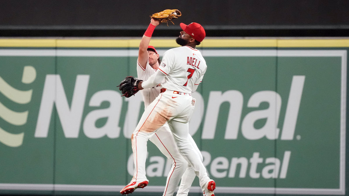 Los Angeles Angels center fielder Bryce Teodosio, left, and right fielder Jo Adell almost collide as Teodosio makes a catch on a ball it by Chicago Cubs' Matt Shaw (not pictured) in the ninth inning at Angel Stadium.