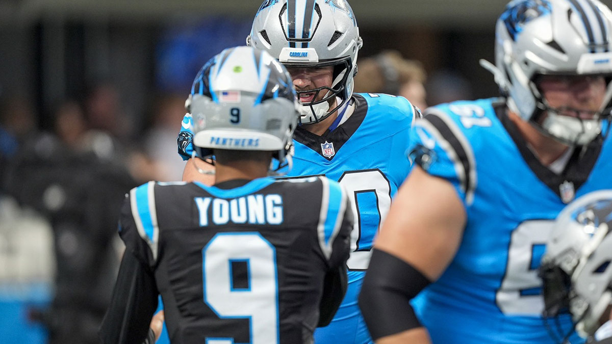 Carolina Panthers quarterback Bryce Young (9) shakes hands with guard Brady Christensen (70) during Fanfest at Bank of America Stadium.