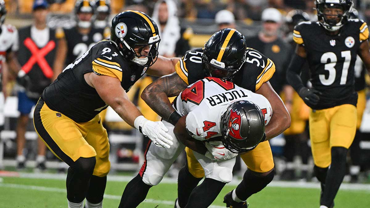 Pittsburgh Steelers linebacker Malik Harrison (50) and defensive tackle Logan Lee (91) tackle Tampa Bay Buccaneers running(44) during the second half at Acrisure Stadium.