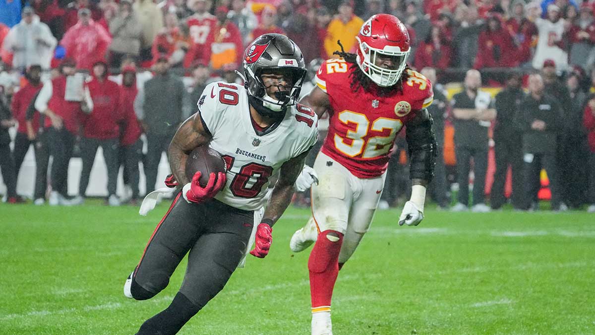 Tampa Bay Buccaneers wide receiver Trey Palmer (10) runs the ball as Kansas City Chiefs linebacker Nick Bolton (32) chases during the second half at GEHA Field at Arrowhead Stadium. 