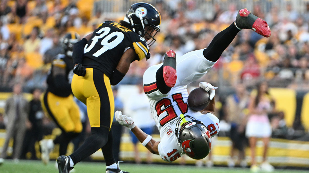 Tampa Bay Buccaneers wide receiver Jalen McMillan (15) makes a catch against Pittsburgh Steelers cornerback Daryl Porter Jr. (39) during the first quarter at Acrisure Stadium.
