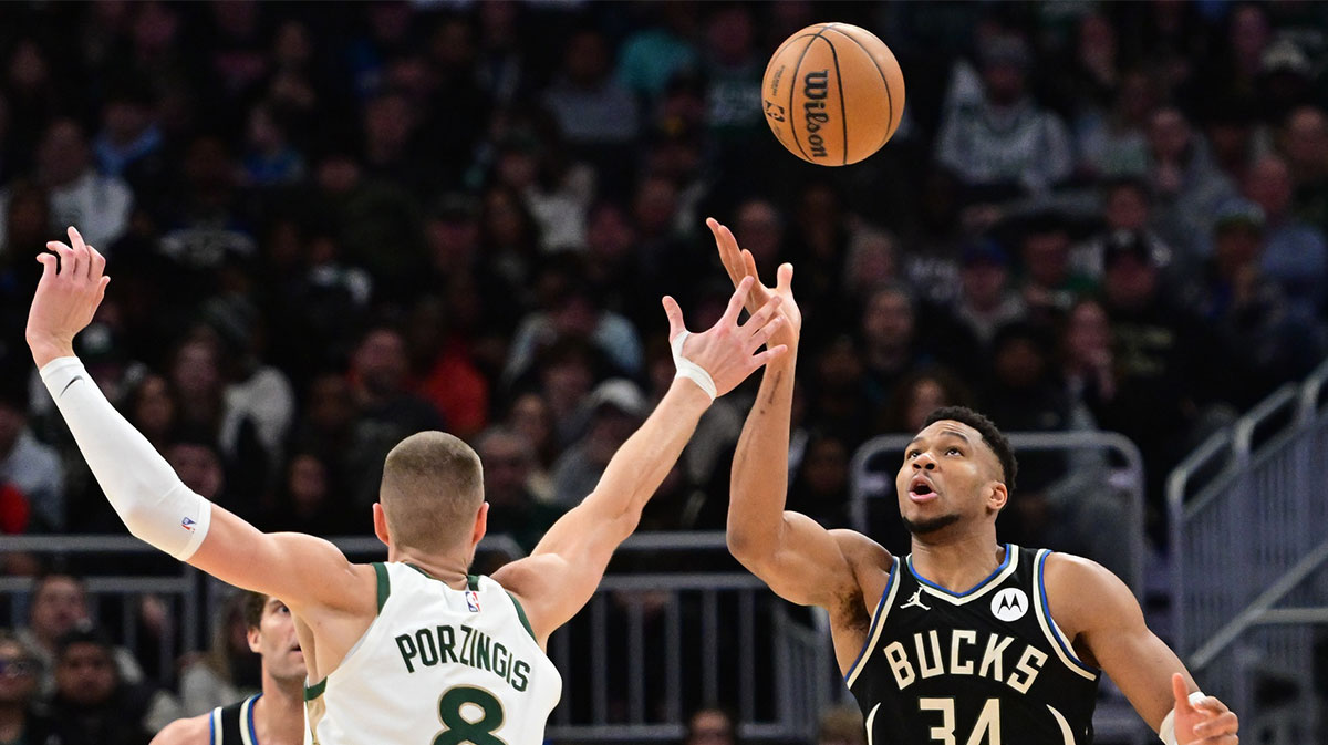 Bucks forward Giannis Antetokounmpo (34) and Boston Celtics center Kristaps Porzingis (8) reach