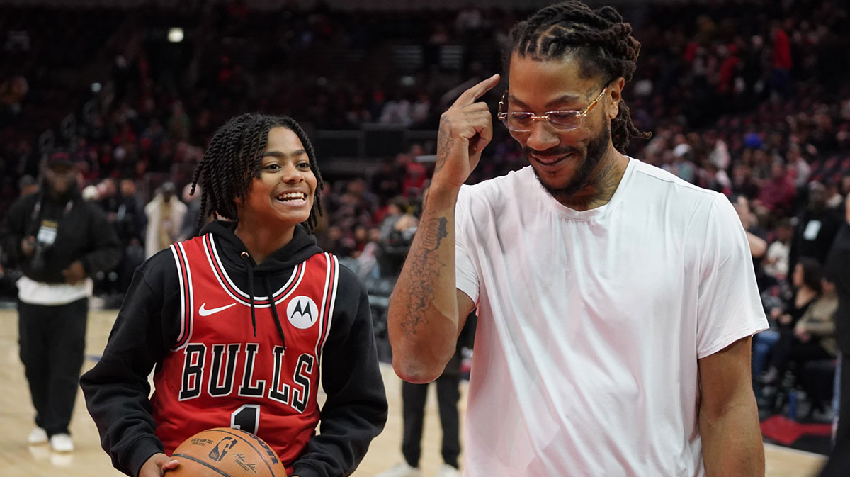 Bulls player Derrick Rose shoots baskets with his son PJ. Rose